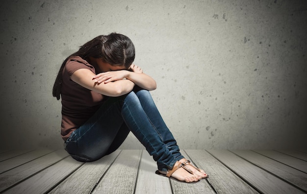 upset woman frustrated by problem sitting on the floor