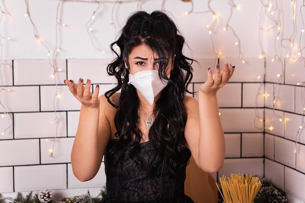 Upset woman on kitchen wear face mask