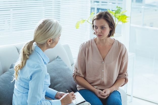 Upset woman talking to therapist