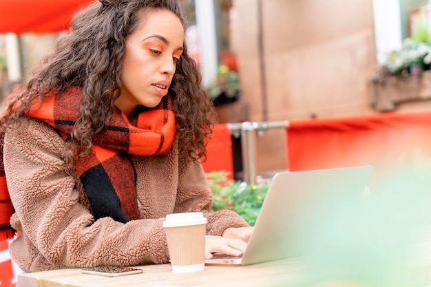 Upset womanl student working  with cup of coffee watching online education webinar using laptop