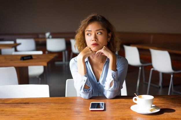 Upset Young Female Manager on her Coffee Break