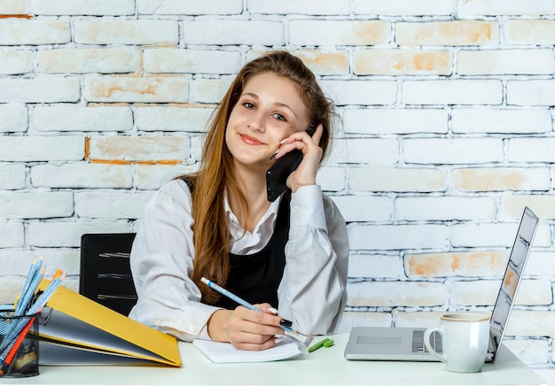 Upset young student stand on white background and talking on the phone High quality photo