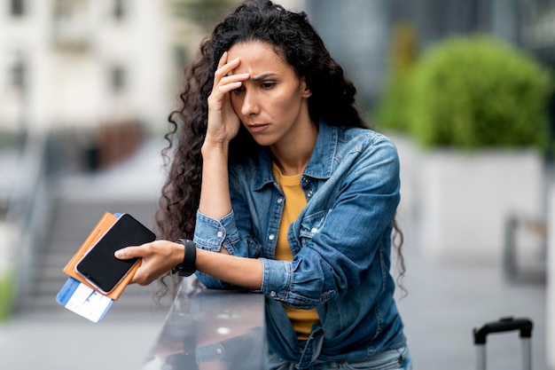 Upset young woman waiting for her delayed flight