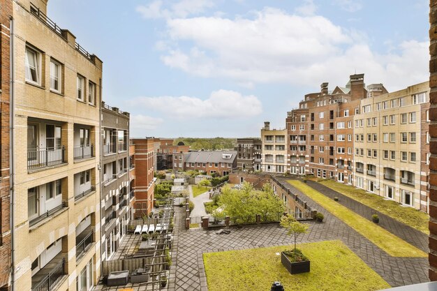 An urban area with buildings and green grass on the roof as seen from one of our apartments in london