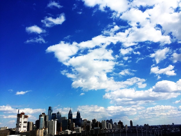 Urban buildings against blue sky and clouds