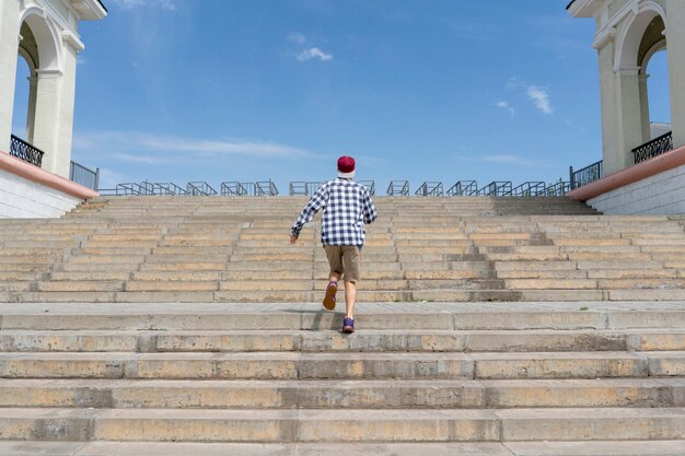 Urban concept, young man walkng on the stairs in the city