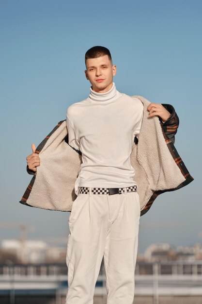 Urban fashion. Young man in loose clothes takes off on the street