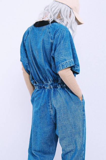 Urban Girl in studio Trendy jeans overalls Blue denim Street StyleFall