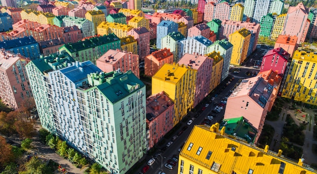 Urban landscape of colorful buildings. Aerial view of the colorful buildings in the European city in the morning sunlight. Cityscape with multicolored houses, cars on the street in Kiev, Ukraine