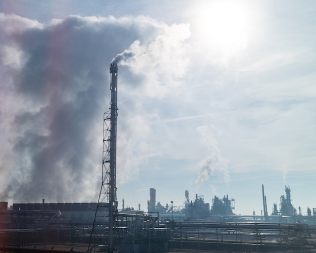 Urban landscape with high smokestack and industrial wastes emission on a big plant or power station in Budapest, Hungary.