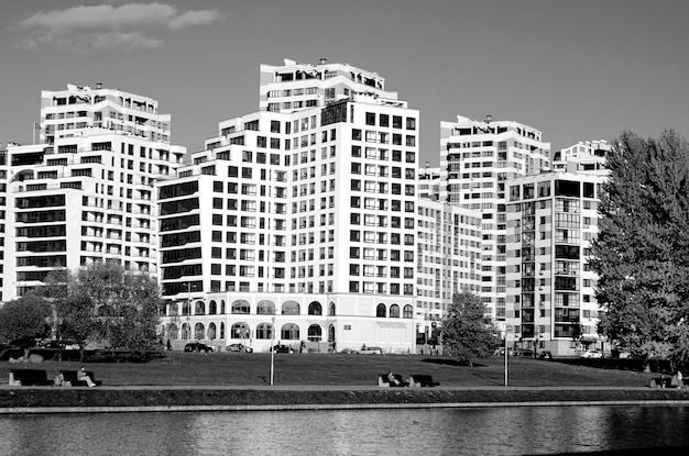 urban landscape with trees and a river on a sunny day black and white photo