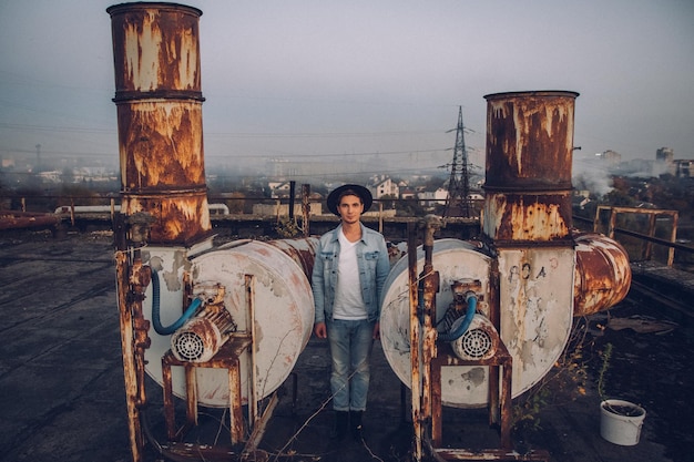 Urban man with hat against the background of the city