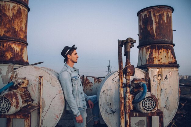 Urban man with hat against the background of the city