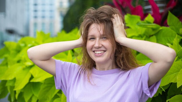 Urban portrait girl young woman with background of greenery in a tropical country young woman smile