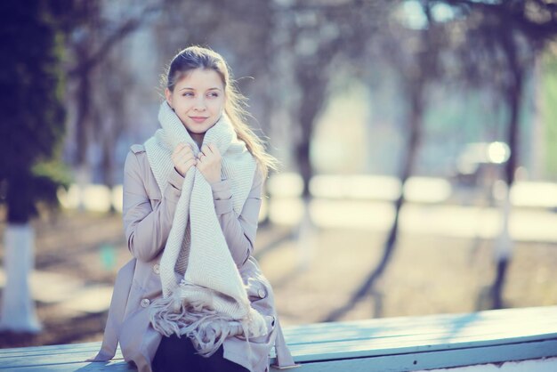 Urban portrait of a happy woman in coat