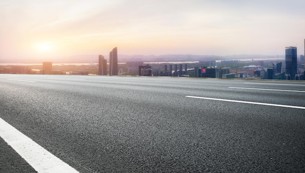 Urban Road at Sunset with City Skyline