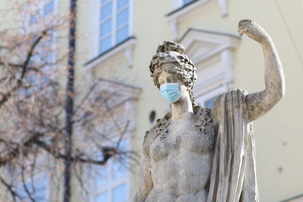 Urban sculpture in a mask. Quarantine in the city of Lviv.