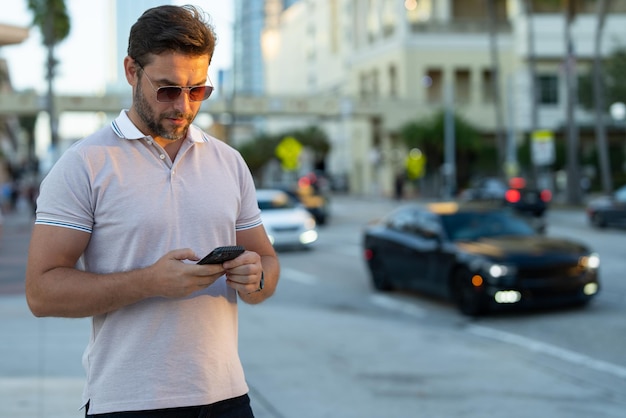 Urban style guy chatting on phone in tampa city portrait of attractive man with casual clothes talki