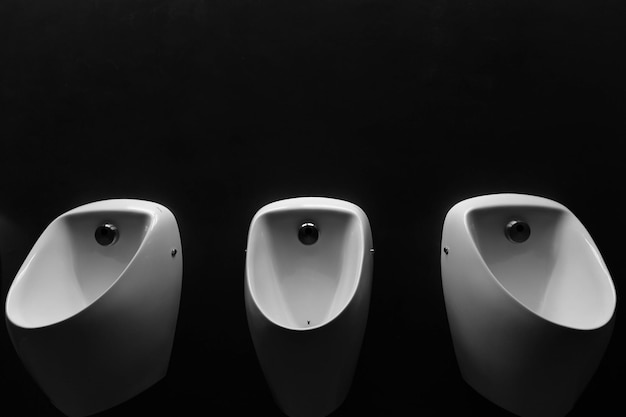 A urinals on black wallxAxA