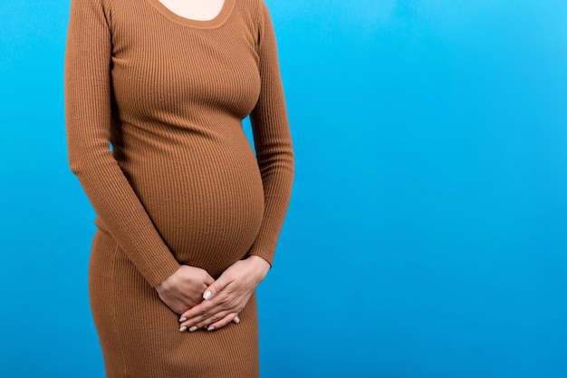 Photo urinary incontinence during pregnancy abdominal pain during pregnancy maternity healthcare concept on colored background