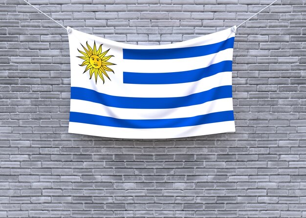 Uruguay flag hanging on brick wall