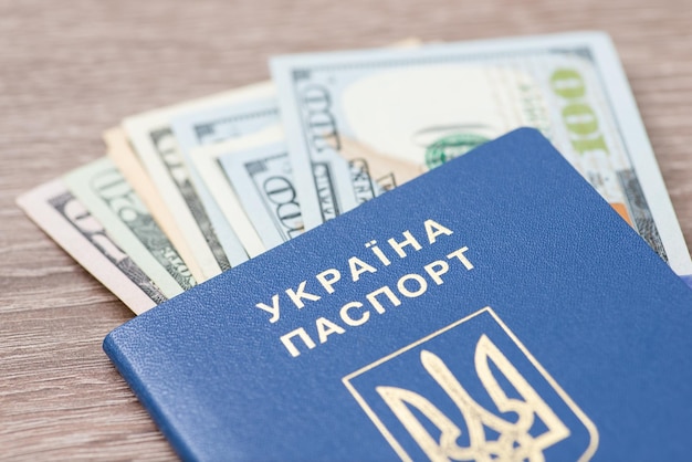 US dollar banknotes in ukrainian passport close up