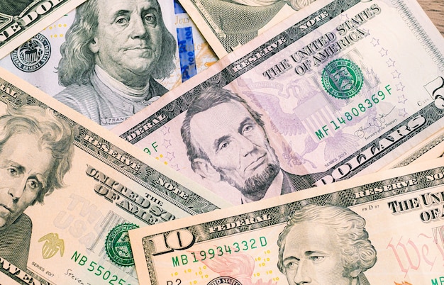 US dollar bills scattered on a table