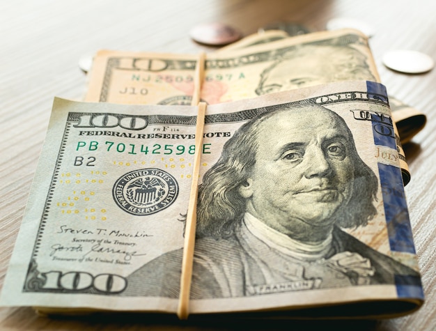 US dollar bills on wooden furniture in closeup photography