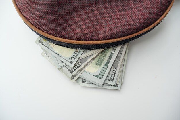 Us dollar cash in leather on pink background