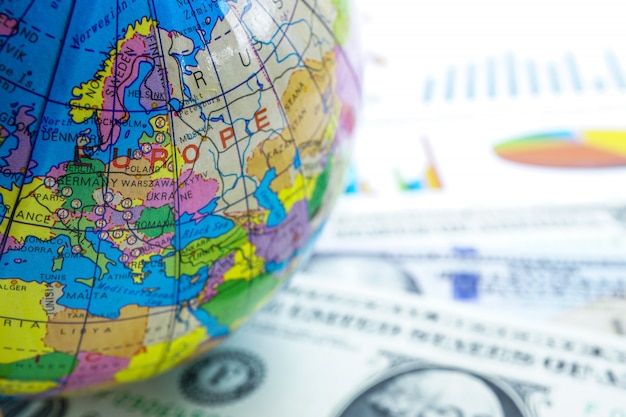 Photo us dollar and graph with europe globe world : banking account, investment economy.