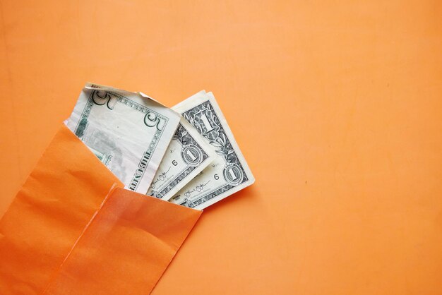 Us dollar in a orange color envelope