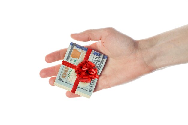 US dollars cash with red ribbon in male hand isolated on white background Gift of American Dollars 100 banknote