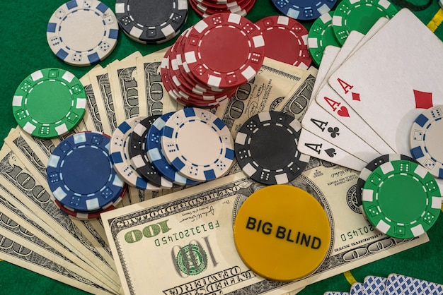 US Dollars play card and poker chips on a gaming table.