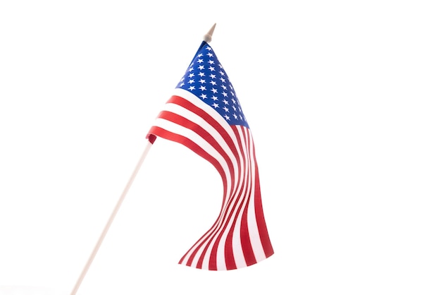 The us flag is developing in the wind against a dark background isolate