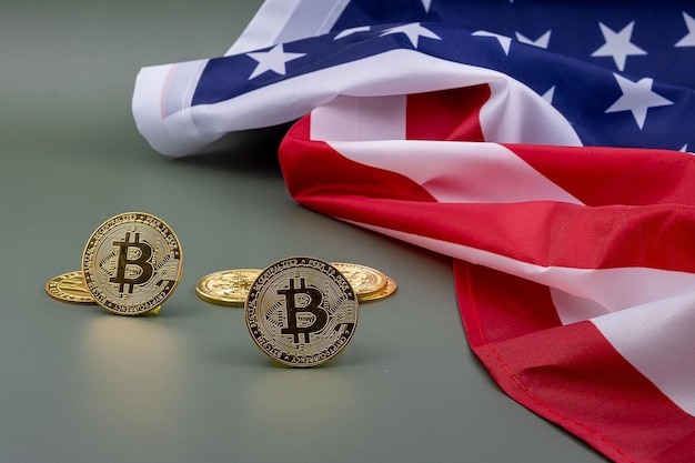 US flag and next to it some bitcoins on a green table