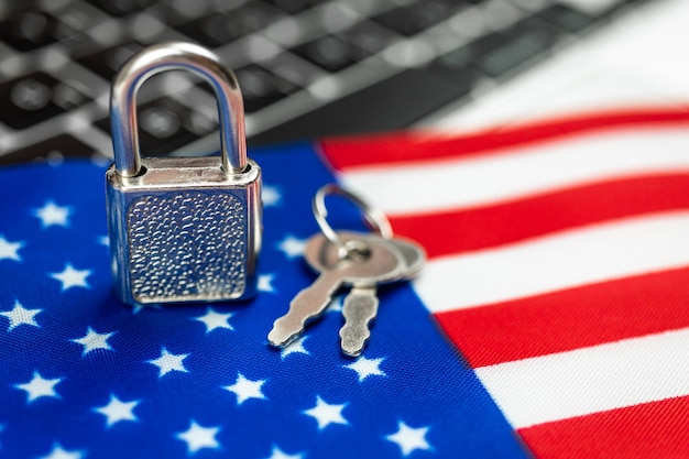 USA cyber security concept Padlock on computer keyboard and American flag Closeup view photo