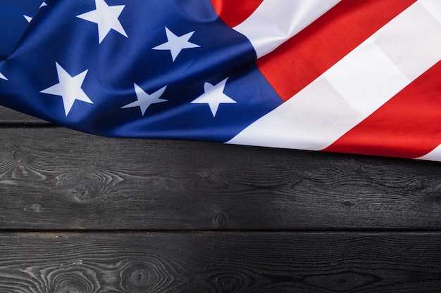 USA flag on dark wooden table 