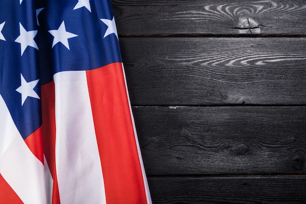 USA flag on dark wooden table 