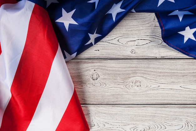 USA flag on light wooden table background close up copy space