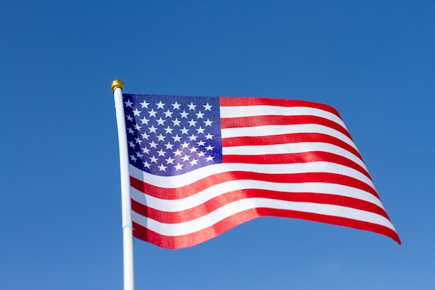 USA flag waving in blue sky. American flag. Celebrating Independence Day of America.