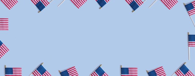 USA flags top view flat lay on blue background with copy space Independence day banner concept