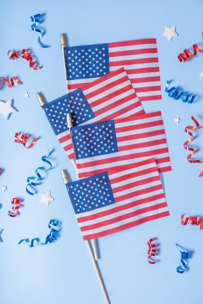 USA Independence day concept USA flags and Red and blue spirals and white stars top view flat lay on blue background