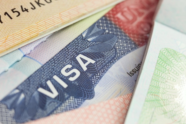 USA visa in a passport selective focus background