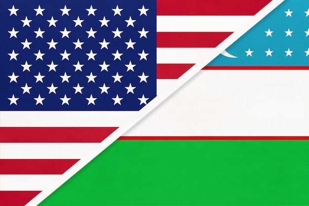 USA vs Uzbekistan national flag from textile. Relationship between two american and asian countries.