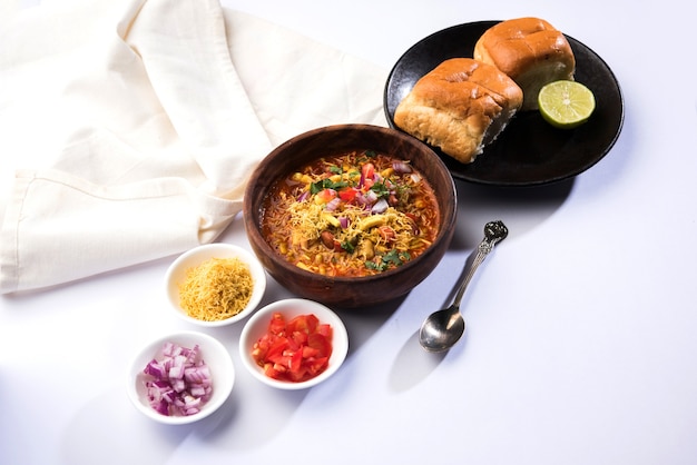 Usal or Misal Pav is a traditional Chat food from Maharashtra, India. Served over moody background. Selective focus