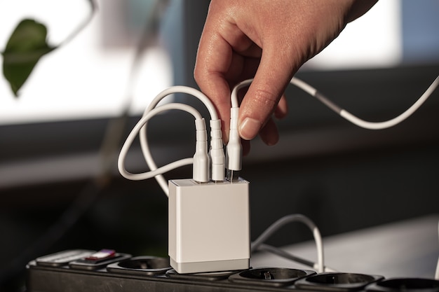 USB charging for gadgets on a blurred background of the room, close-up. The concept of technology in everyday life.