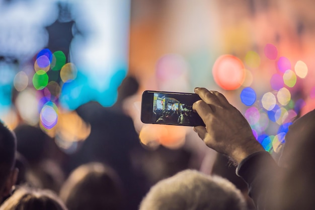 Use advanced mobile recording fun concerts and beautiful
lighting candid image of crowd at rock concert close up of
recording video with smartphone enjoy the use of mobile
photography