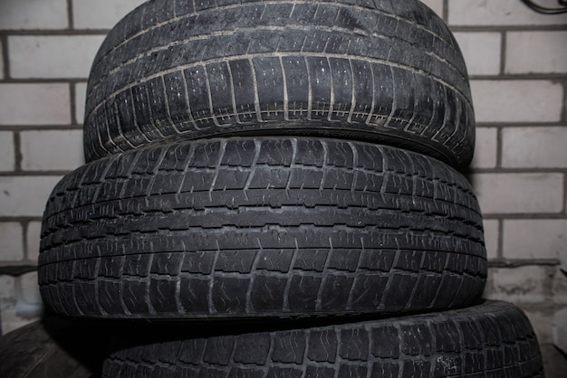 Used auto wheels folded horizontally. Discarded summer car tires, worn out tread.