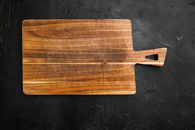 Photo used bamboo chopping board empty for empty for copy space for text or food, top view flat lay , on black dark stone table background