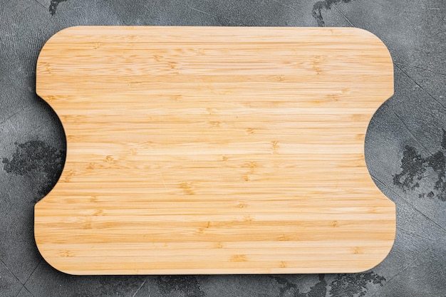 Used bamboo chopping board empty for empty for copy space for\
text or food top view flat lay on gray stone table background